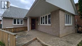Toronto (Downsview-Roding-Cfb) apartment for rent - A house with a brown brick exterior and a grey roof.