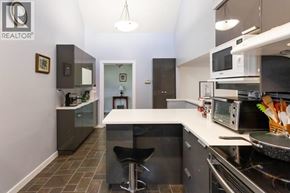Richmond apartment for rent - A kitchen with a white counter top and a black stool.
