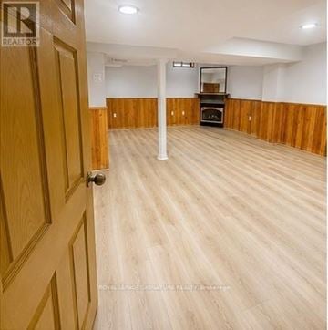 Brampton (Sandringham-Wellington) townhouse for rent - A room with wooden floors and a door on the left.