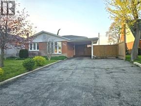 Cambridge apartment for rent - A residential house with a driveway and a fence.