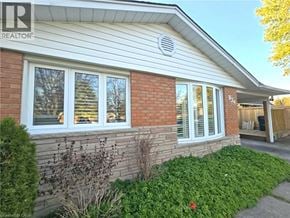 Cambridge apartment for rent - A house with a white siding and a brick wall with windows and a door.