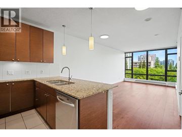 Richmond apartment for rent - A kitchen with wooden cabinets and a granite countertop.