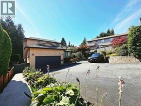 North Vancouver apartment for rent - A house with a garage and a car parked in front.