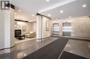 Hamilton condo for rent - A hallway with a marble floor and a fireplace.
