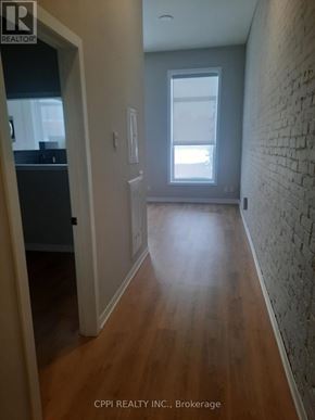 Peterborough (Town Ward 3) condo for rent - A hallway with wood floors and a brick wall.