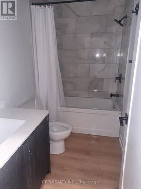 Peterborough (Town Ward 3) condo for rent - A bathroom with a toilet, sink, and shower.