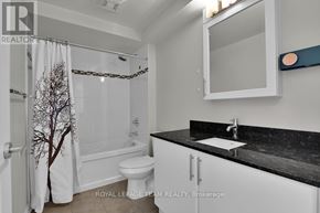 Ottawa condo for rent - A bathroom with a toilet, sink, and shower.