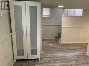 Toronto (Clairlea-Birchmount) apartment for rent - A room with a glass door cabinet and wooden flooring.