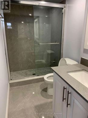 Toronto (Clairlea-Birchmount) apartment for rent - A bathroom with a walk-in shower and a toilet.