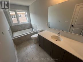 Pickering townhouse for rent - A bathroom with a toilet, sink, and bathtub.