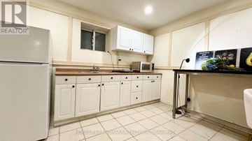 Markham (Aileen-Willowbrook) apartment for rent - A kitchen with white cabinets and a white fridge.