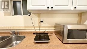 Markham (Aileen-Willowbrook) apartment for rent - A kitchen counter with a microwave and a sink.