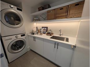 White Rock apartment for rent - A small laundry room with a washer and dryer.