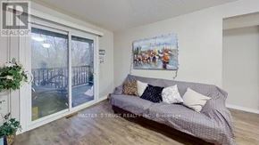 Waterloo condo for rent - A living room with a grey couch and a painting of a family on the wall.