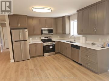 Mcnab/Braeside apartment for rent - A kitchen with wooden floors and beige cabinets.