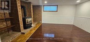 Toronto (Rustic) apartment for rent - A room with a wood stove and a window.