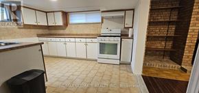 Toronto (Rustic) apartment for rent - A kitchen with white cabinets and a brick wall.