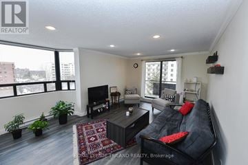 London South (South E) condo for rent - A living room with a black couch and a television.