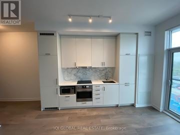 Vaughan (Vaughan Corporate Centre) condo for rent - A modern kitchen with white cabinets and appliances.
