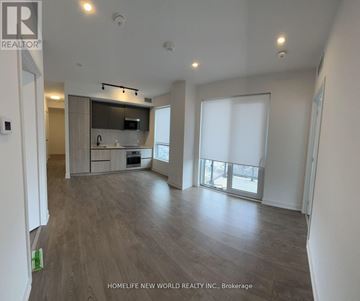 Toronto (Waterfront Communities) condo for rent - A spacious living room with a kitchen area in the background.