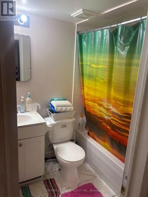 Mississauga (Meadowvale Village) apartment for rent - A bathroom with a toilet, sink, and shower curtain.