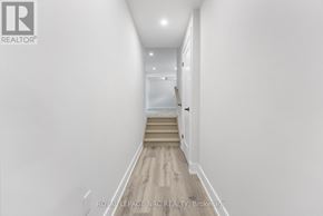 Welland (Welland Downtown) apartment for rent - A long hallway with a staircase leading to the second floor.