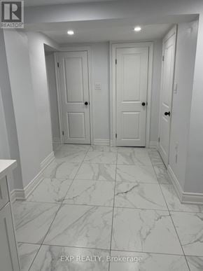 Toronto (Dorset Park) apartment for rent - A hallway with marble floors and white walls.
