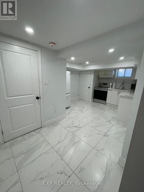 Toronto (Dorset Park) apartment for rent - A white marble tiled kitchen and living room with a sliding door.