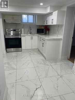 Toronto (Dorset Park) apartment for rent - A white kitchen with a marble floor.
