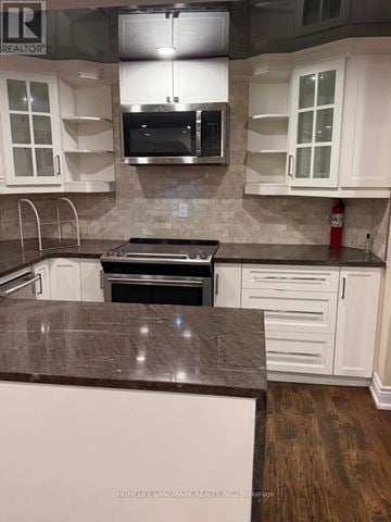 Richmond Hill (Westbrook) apartment for rent - A kitchen with white cabinets and a brown countertop.