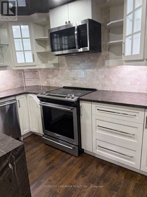 Richmond Hill (Westbrook) apartment for rent - A kitchen with a black microwave above the stove.