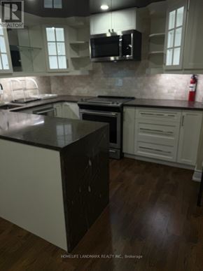 Richmond Hill (Westbrook) apartment for rent - A kitchen with a black counter top and white cabinets.