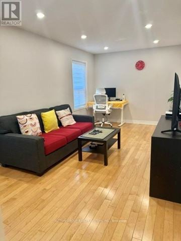 Mississauga (Hurontario) apartment for rent - A living room with a black couch and a coffee table.