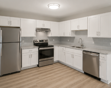 San Antonio apartment for rent - A kitchen with white cabinets and stainless steel appliances.