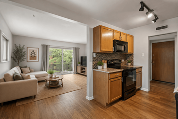 Denver apartment for rent - A modern kitchen with wooden cabinets and appliances.