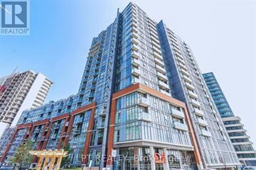 Toronto (Little Portugal) condo for rent - A tall building with the words "REALTOR" on the top left corner.