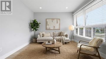 Greater Sudbury apartment for rent - A living room with a brown rug and a wooden coffee table.