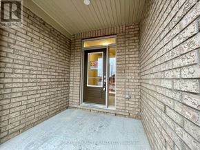Oshawa (Windfields) townhouse for rent - A doorway with a glass door and a sign on it.