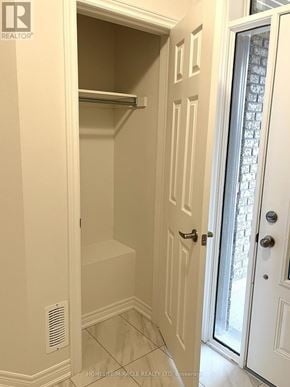 Oshawa (Windfields) townhouse for rent - A white door with a glass panel and a handle.