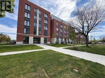 London East (East K) condo for rent - A brick building with a tree in front of it.