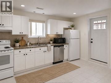 Windsor apartment for rent - A kitchen with white cabinets and appliances.