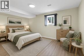 Windsor apartment for rent - A bedroom with a bed, chair, and nightstands.