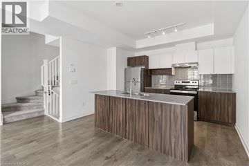 Burlington townhouse for rent - A modern kitchen with wooden cabinets and a stainless steel refrigerator.