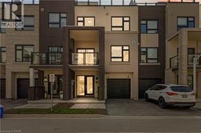 Burlington townhouse for rent - A white car is parked in front of a building with a realtor sign.