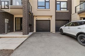 Burlington townhouse for rent - A white car is parked in front of a black garage door.