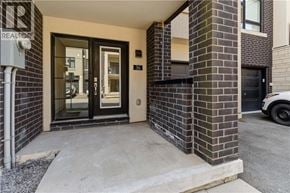 Burlington townhouse for rent - A modern house entrance with a glass door and a brick wall.