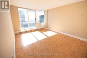 Toronto (Playter Estates-Danforth) condo for rent - A room with a wooden floor and a sliding glass door leading to a balcony.