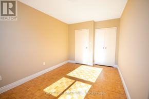 Toronto (Playter Estates-Danforth) condo for rent - A room with wooden flooring and two white doors.