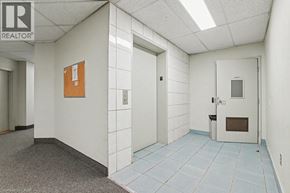 Kitchener condo for rent - A hallway with a Realtor sign on the wall.