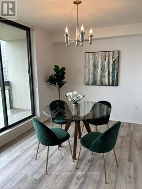 Toronto (Don Valley Village) condo for rent - A dining room with a glass table and green chairs.